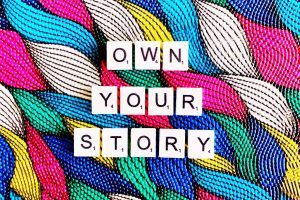 Own you story written on colorful background